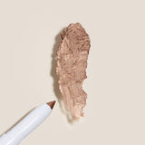 Swatch of Rose Colored Glasses, a rose gold shimmer of the cream eye shadow stick for a natural shimmer that highlights eyes